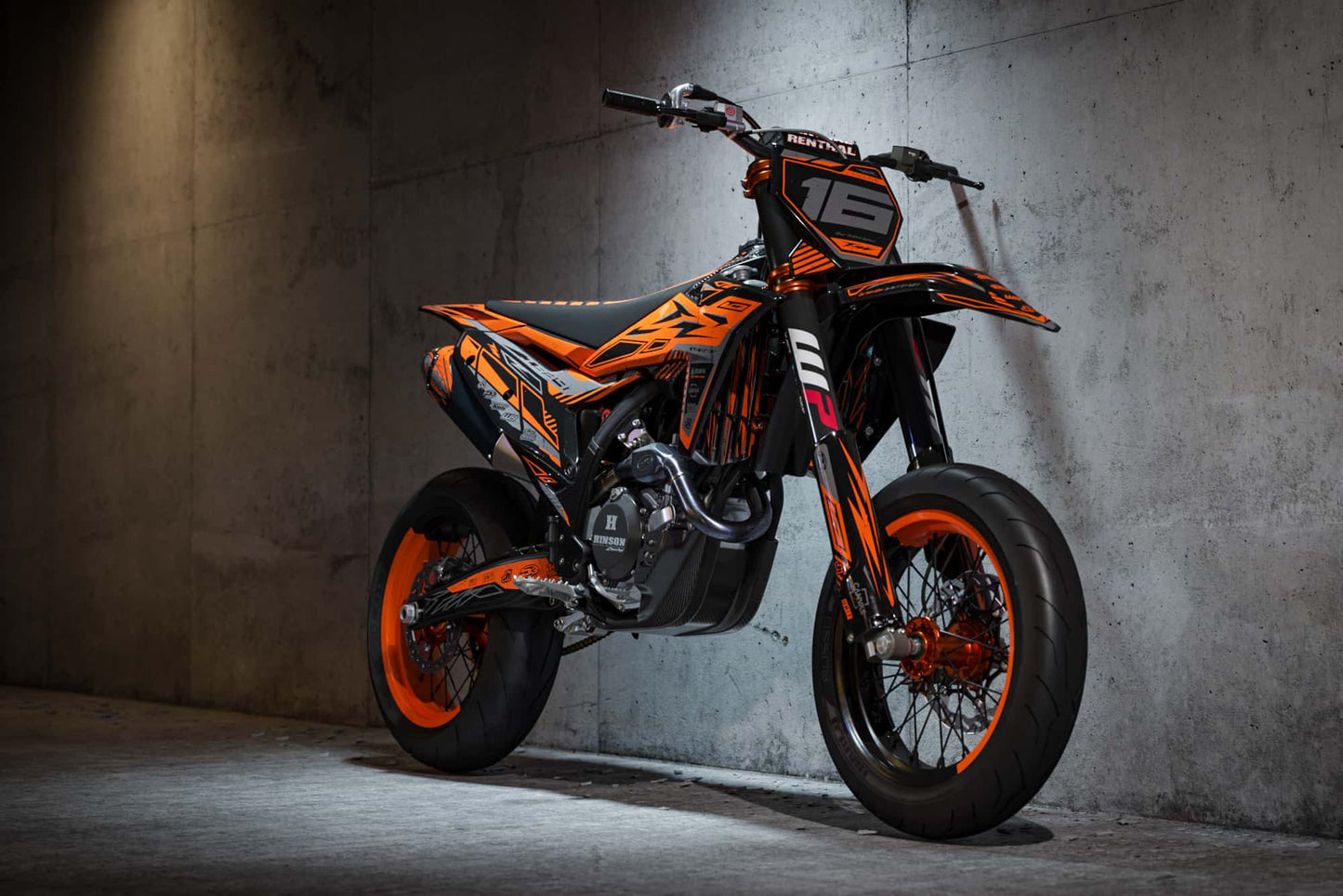 Promotional view of the Omega Orange custom decal kit on a KTM supermoto bike.
