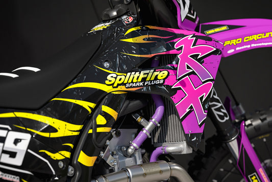 Promotional image of the Flame Purple graphics kit for a Kawasaki motocross bike.