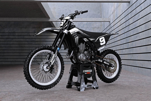 Promotional image of the SHIFT Black graphics kit for a Kawasaki motocross bike.