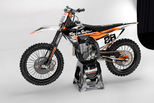 Promotional view of the Pro Orange custom decal kit on a KTM dirt bike.