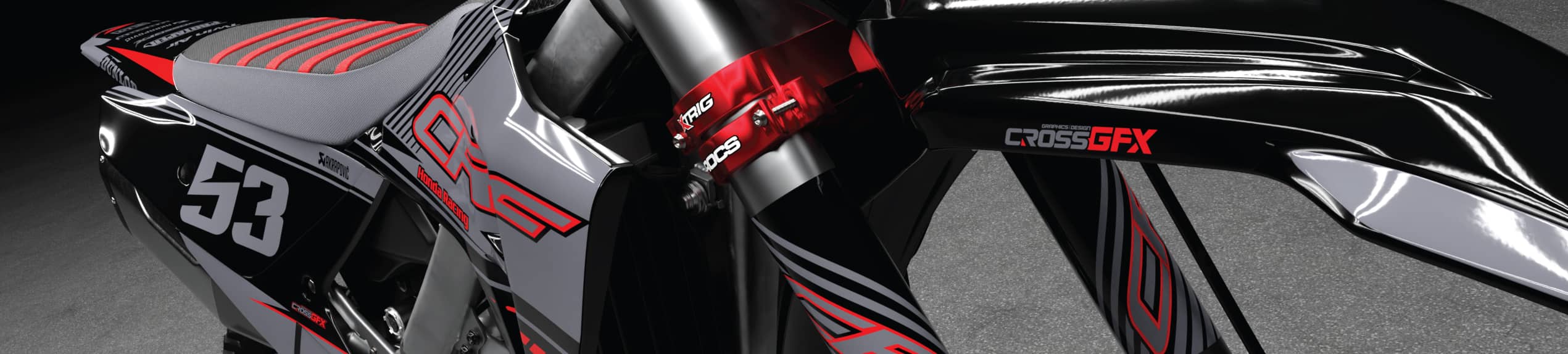 Close-up of a dirt bike with CRF branding on a dark background