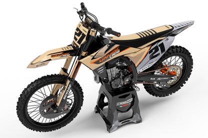 Left side view of the Orange Crew racing graphics kit on a KTM dirt bike.