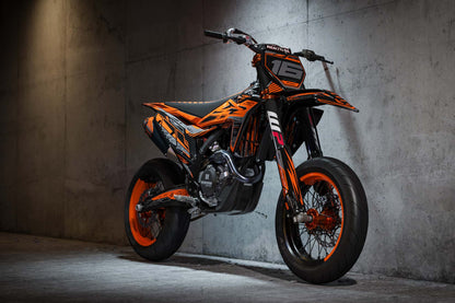 Promotional view of the Omega Orange custom decal kit on a KTM supermoto bike.