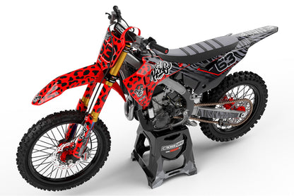 Left side view of the Red Panther racing graphics kit on a Honda dirt bike.