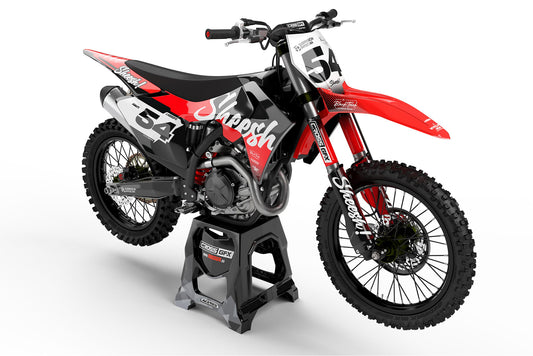 Front view of the Sheesh Black motocross graphics kit on a GasGas dirt bike.