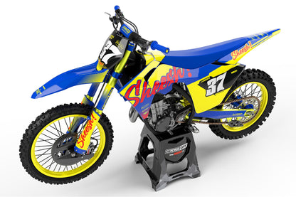 Side view of the Sheesh Yellow racing graphics kit on a GasGas dirt bike.