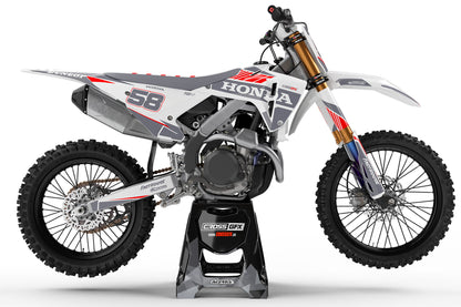Left side view of the Blitz White graphics kit on a Honda dirt bike.