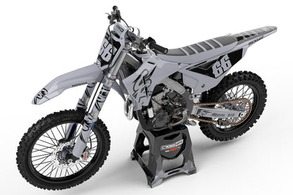 Side view of the Retro 94 Grey motocross graphics kit on a Honda racing bike.