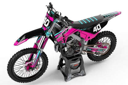 Left side view of the Surge Pink graphics kit on a Honda dirt bike.