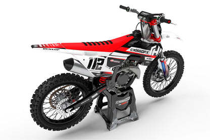 Rear view of the Xcel Red racing graphics kit on a Husqvarna dirt bike.