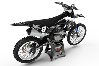 Rear view of the SHIFT Black graphics kit on a Kawasaki dirt bike.